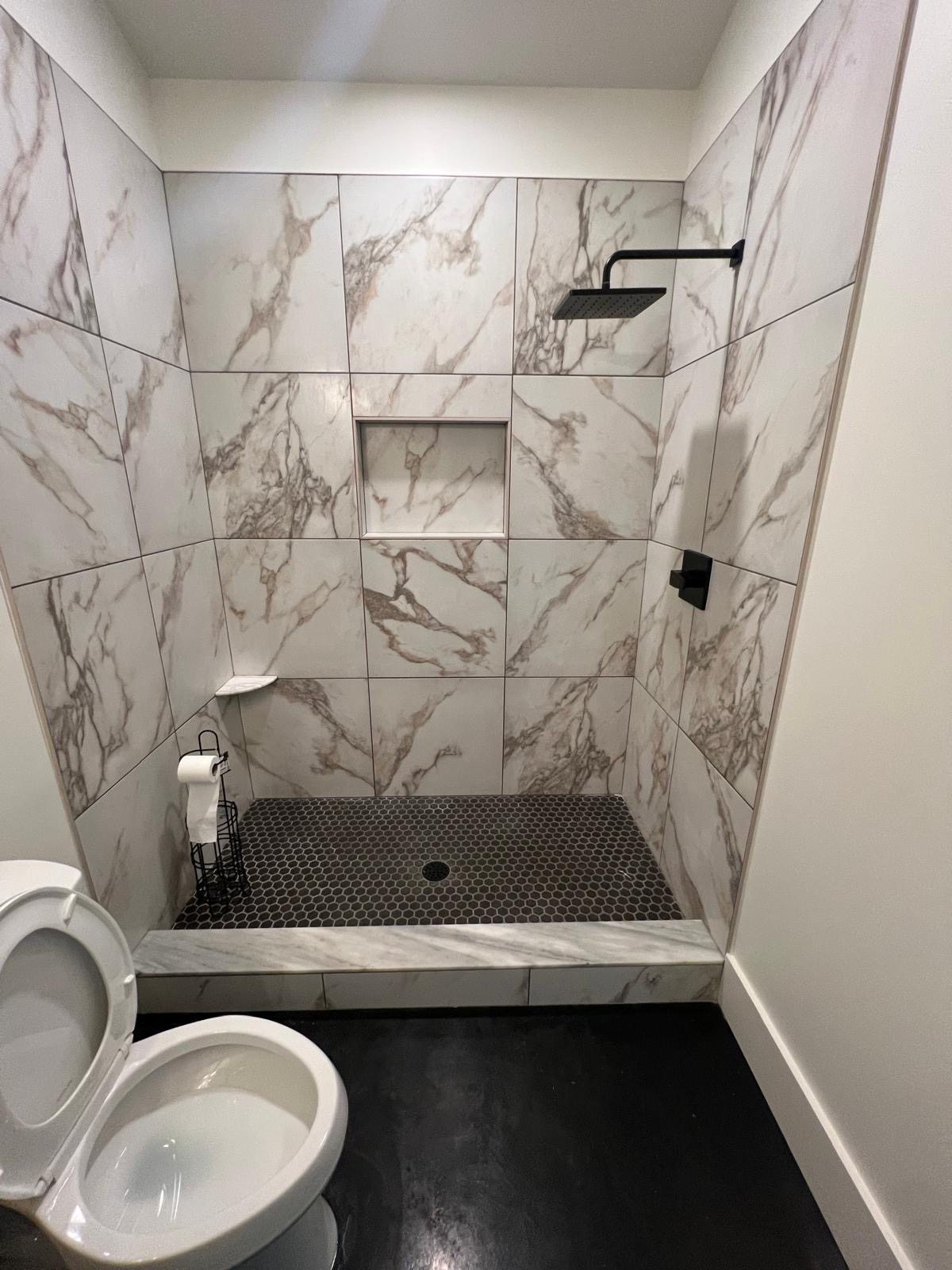 Custom tile shower remodel with marble tile and black fixtures – JRM Plumbing Raleigh NC